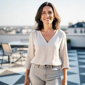 Portrait of a French woman in her late 30s, smiling naturally, standing on a modern tiled terrace, soft natural light, shallow depth of field, authentic lifestyle photography, high resolution
